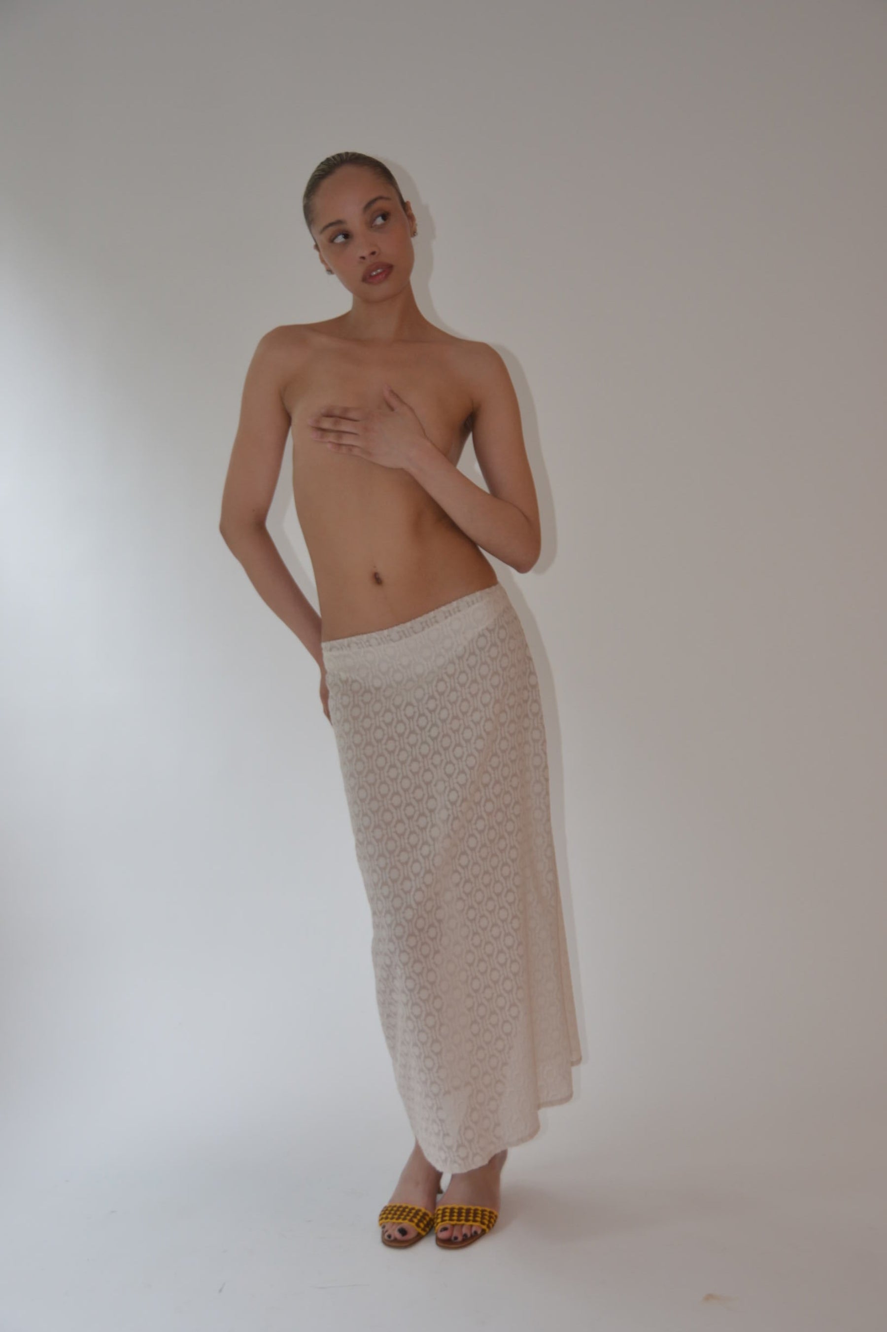 Person lying on a white towel on a white background