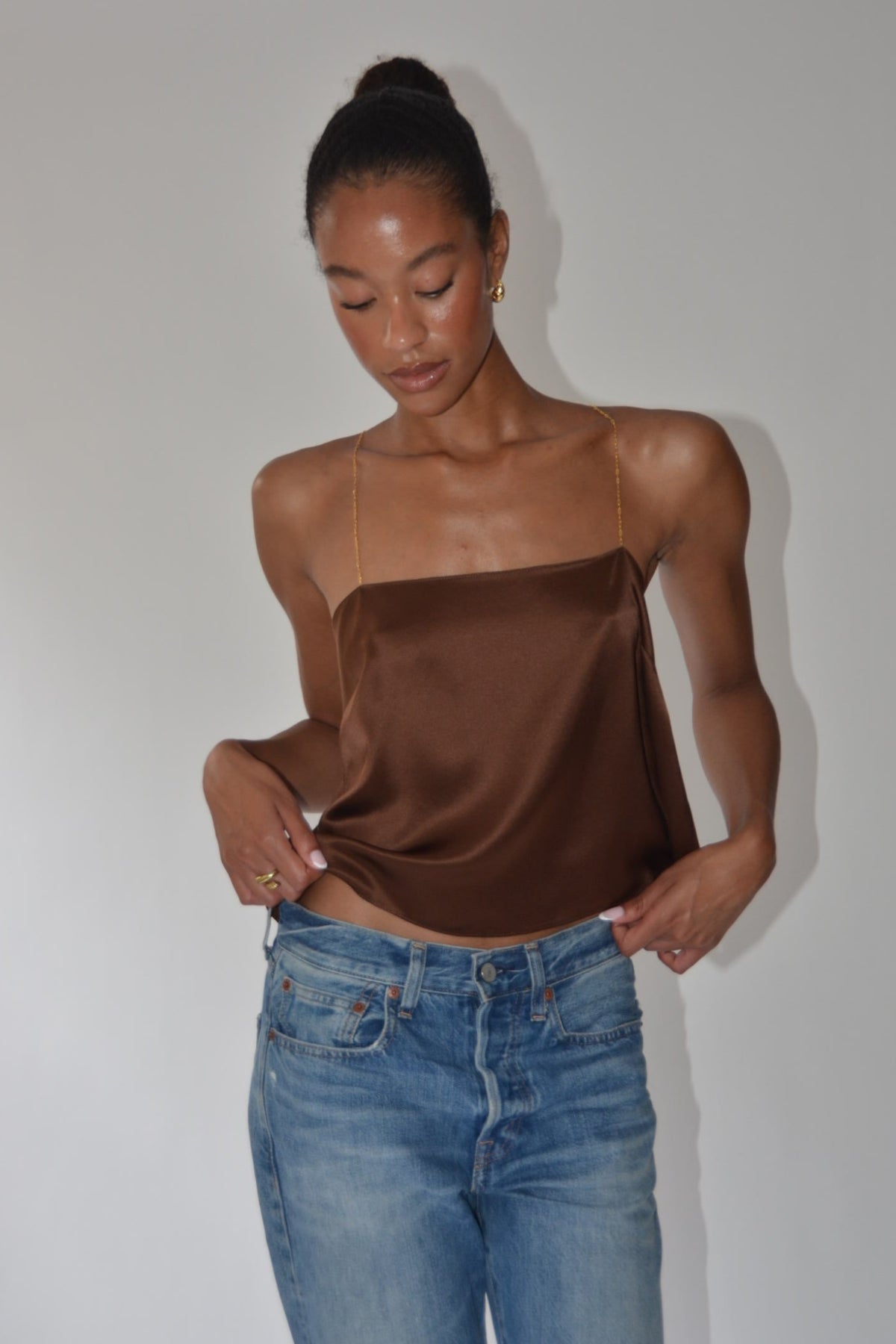 model with brown silk cami tank with gold chain