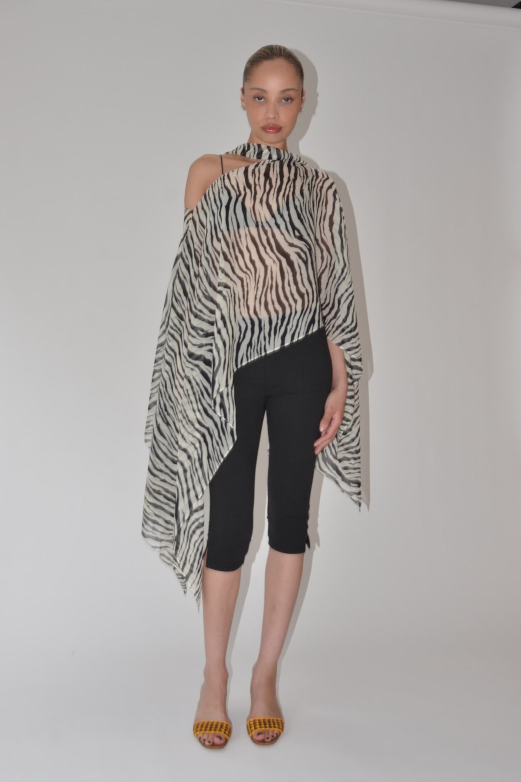 Person wearing a zebra print dress on a plain background