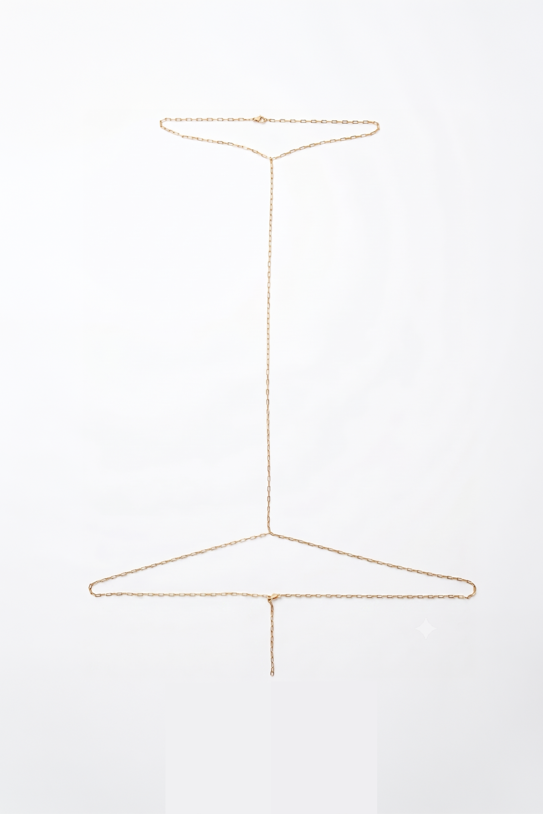 A delicate gold harness photographed against a seamless white background.